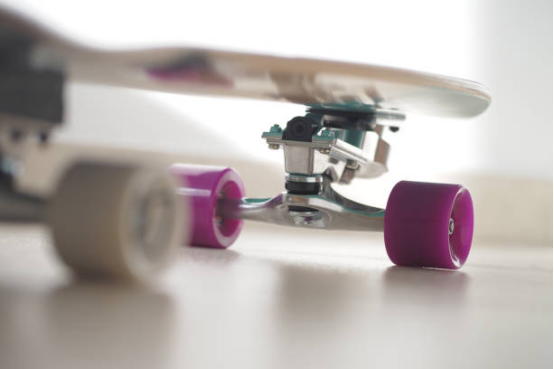 Downhill skater carving with precision using specialized wheels.
