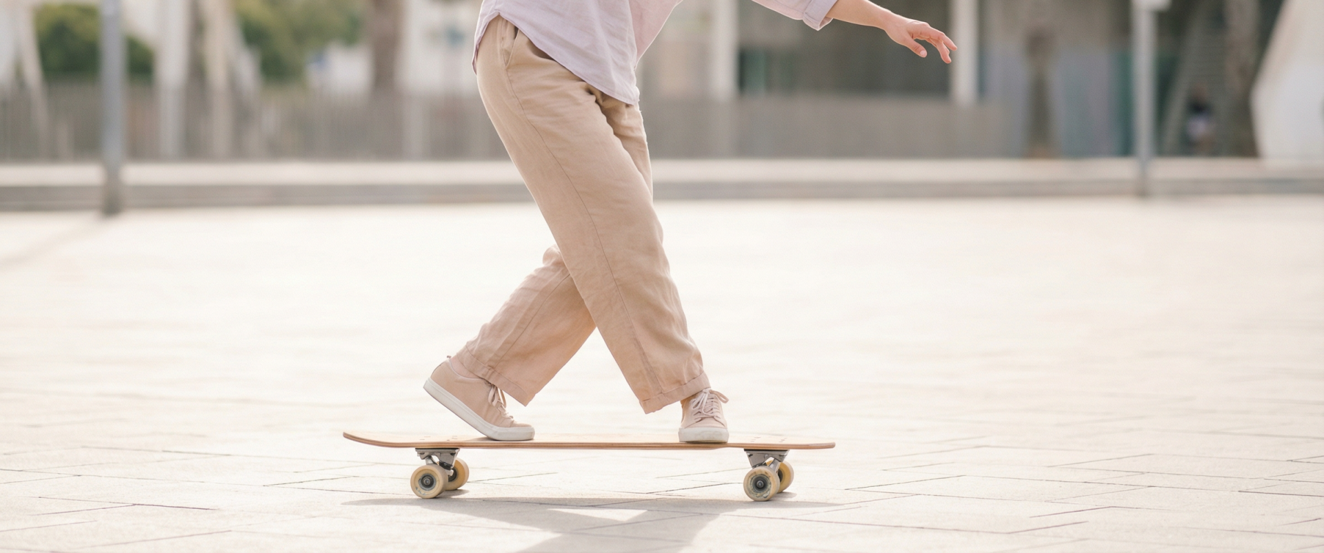 Longboard dancer performing cross-step footwork — one foot crossing over the other mid-step on a 110cm dancing longboard
