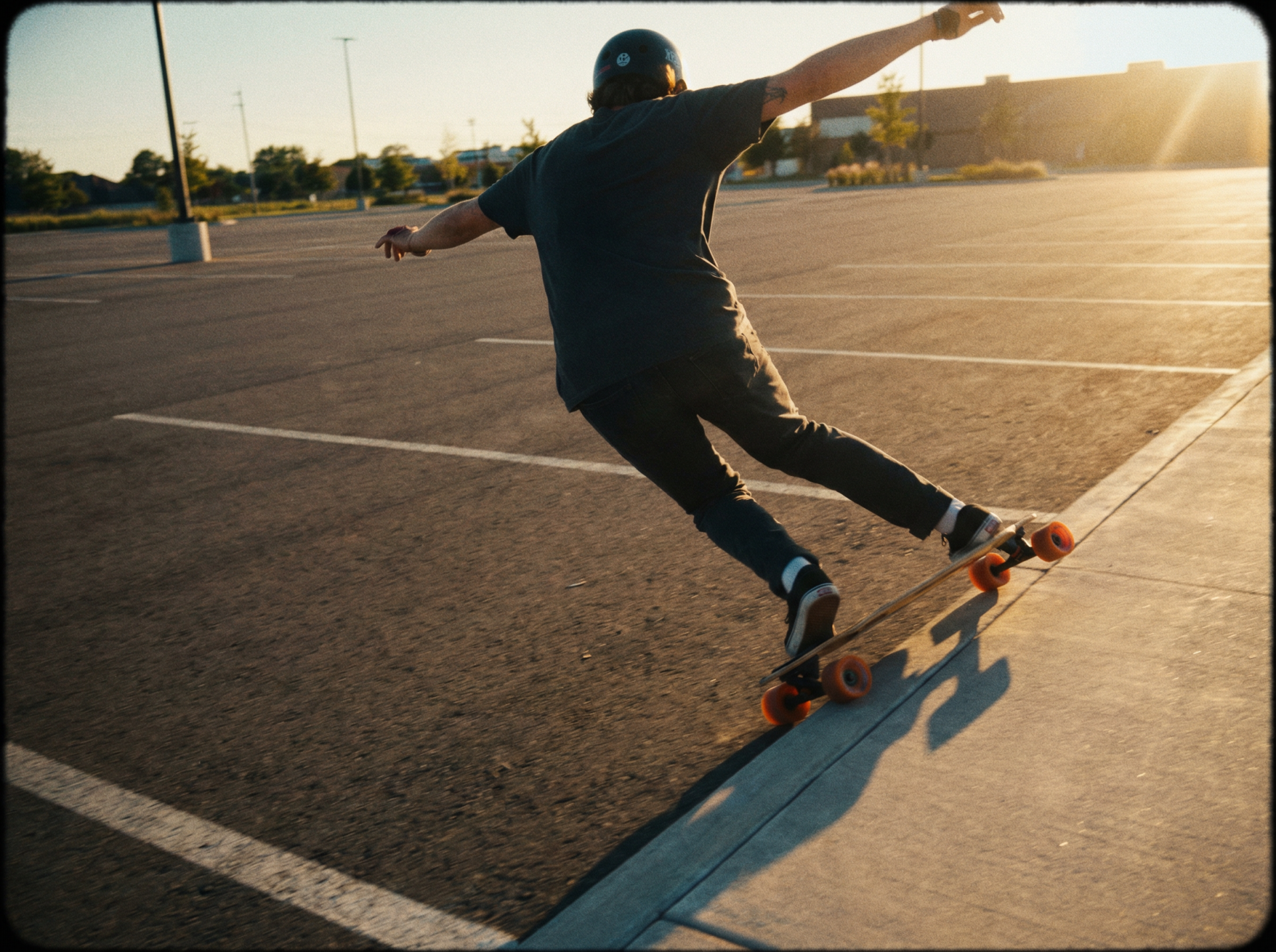 Longboarder leaning into a heelside turn — board tilted, arms extended for balance on smooth pavement